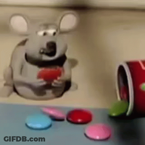 A Cartoon Mouse Is Sitting On A Table Next To A Can Of Candy . GIF