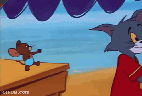 A Cartoon Mouse Is Standing On A Table Next To A Striped Balloon . GIF