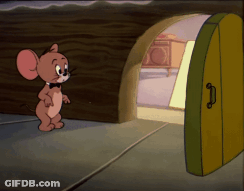 A Cartoon Mouse Named Jerry Is Standing In Front Of An Open Door GIF