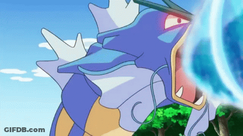 A Cartoon Of A Blue And Yellow Pokemon With Its Mouth Open And A Blue Light Coming Out Of It 'S Mouth . GIF