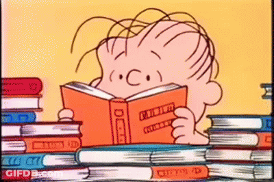 A Cartoon Of A Boy Reading A Book In Front Of A Stack Of Books . GIF