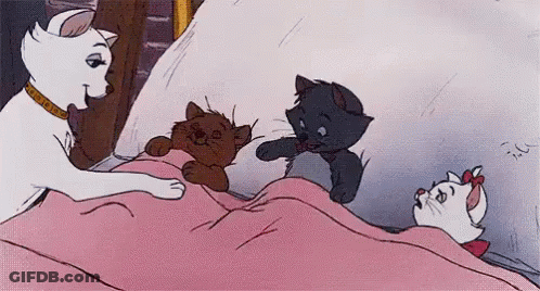 A Cartoon Of A Cat And Three Kittens Laying On A Bed . GIF