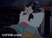 A Cartoon Of A Cat Laying On A Couch GIF