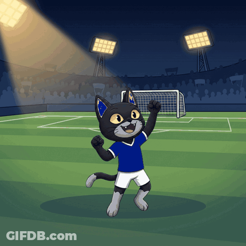 A Cartoon Of A Cat Wearing A Blue Shirt And White Shorts Standing On A Soccer Field GIF