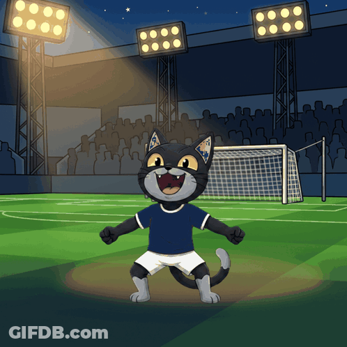 A Cartoon Of A Cat Wearing A Blue Shirt And White Shorts Standing On A Soccer Field GIF