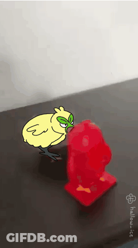 Chicken With Green Mask Next To Red Object GIF