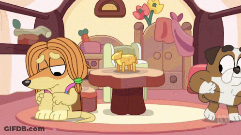 A Cartoon Of A Dog Sitting Next To A Table With A Sheep On It GIF