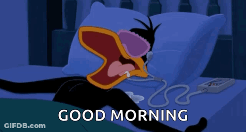 A Cartoon Of A Duck Laying On A Bed With The Words Good Morning Above Him GIF