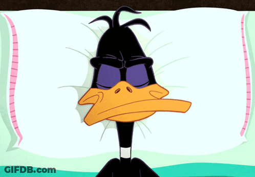 A Cartoon Of A Duck Laying On A Pillow With His Eyes Closed GIF