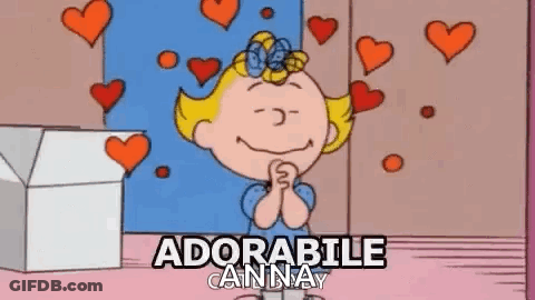 A Cartoon Of A Girl With Hearts Around Her And The Words `` Adorabile Anna '' Written Above Her . GIF