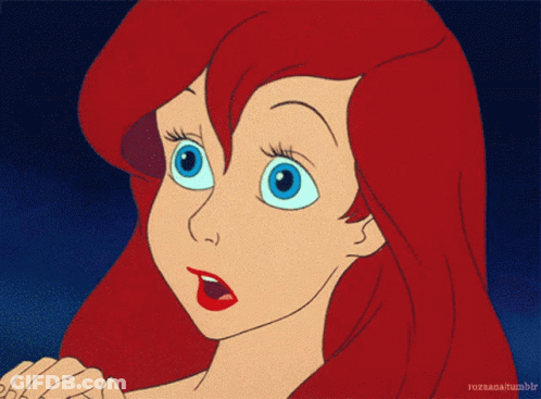 A Cartoon Of A Girl With Red Hair And Blue Eyes GIF