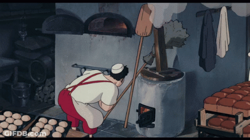 A Cartoon Of A Man Baking Bread In A Kitchen GIF