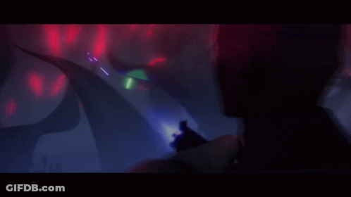 A Cartoon Of A Man Holding A Gun With A Light Coming Out Of It GIF