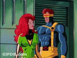 A Cartoon Of A Man In A Blue Suit And A Woman With Red Hair Standing Next To Each Other GIF