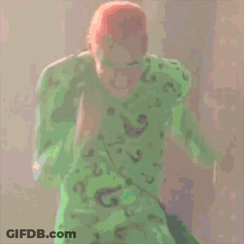 A Cartoon Of A Man In A Green Shirt And Green Mask GIF
