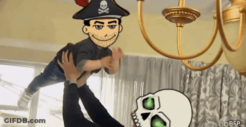 A Cartoon Of A Man In A Pirate Hat Is Being Held Up By Another Person GIF
