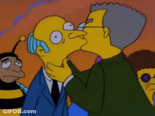 A Cartoon Of A Man Kissing Another Man 'S Face GIF