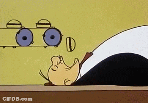 A Cartoon Of A Man Laying On A Table With His Head On A Table . GIF