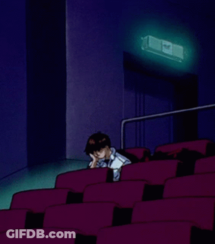A Cartoon Of A Man Sitting In An Auditorium With A Projector Behind Him GIF
