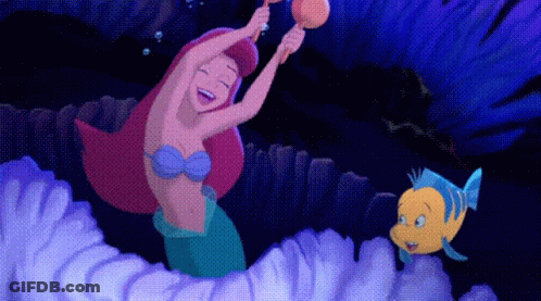 A Cartoon Of A Mermaid And A Fish Playing A Musical Instrument GIF