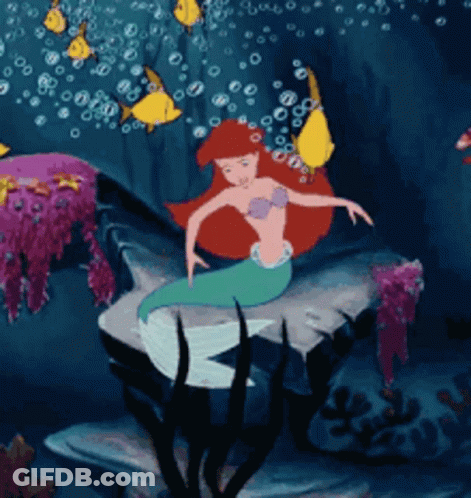 A Cartoon Of A Mermaid In The Ocean GIF