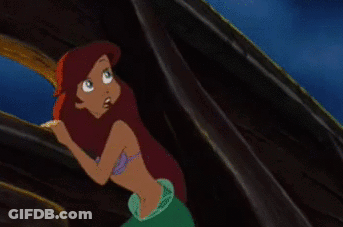 A Cartoon Of A Mermaid With Red Hair Is Standing In Front Of A Window GIF
