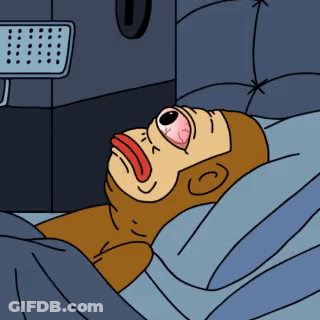 A Cartoon Of A Monkey Laying In A Bed With His Eyes Closed GIF