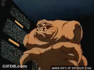 A Cartoon Of A Monster With Horns Standing In Front Of A Television Screen . GIF
