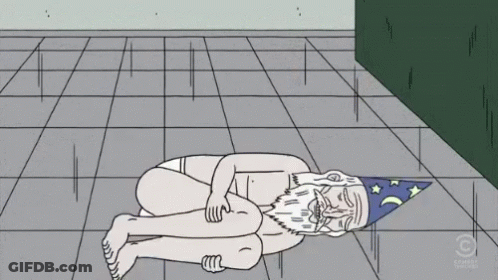 A Cartoon Of A Naked Man With A Wizard Hat Laying On The Ground GIF