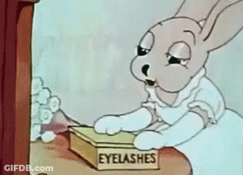 A Cartoon Of A Rabbit Looking At A Box Of Eyelashes GIF