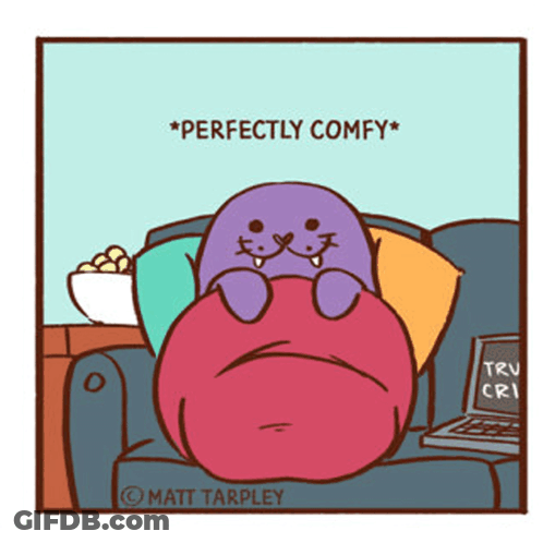 A Cartoon Of A Seal Sitting On A Couch With The Words Perfectly Comfy On The Bottom GIF