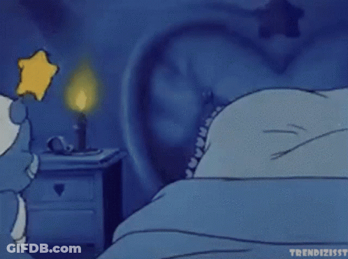 A Cartoon Of A Smurf Sleeping In A Bed With A Star On His Head GIF