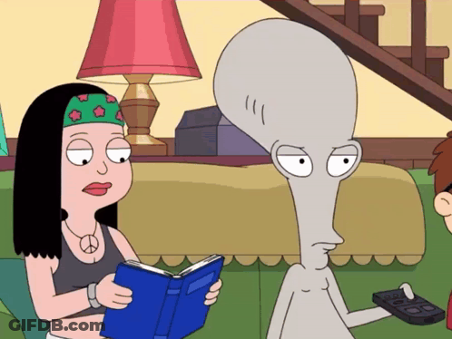 Woman Reading Book Next To Grey Alien GIF