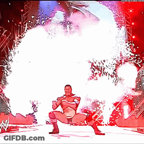 A Cartoon Of A Wrestler Standing In Front Of A Fireworks Display With The Letters W On The Bottom GIF