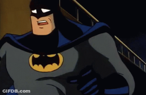 A Cartoon Of Batman Is Standing In Front Of A Building With His Mouth Open . GIF