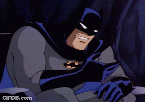 A Cartoon Of Batman Reading A Book With A Smile On His Face GIF