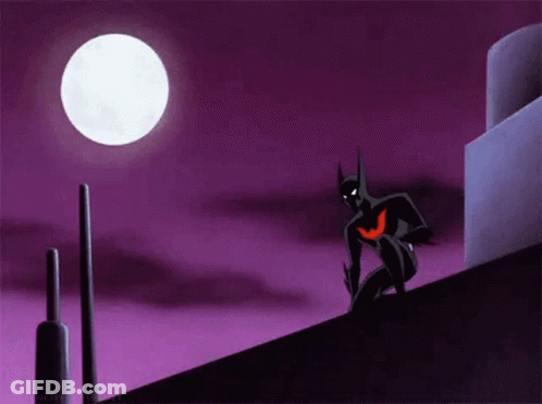 A Cartoon Of Batman Standing On Top Of A Building At Night . GIF