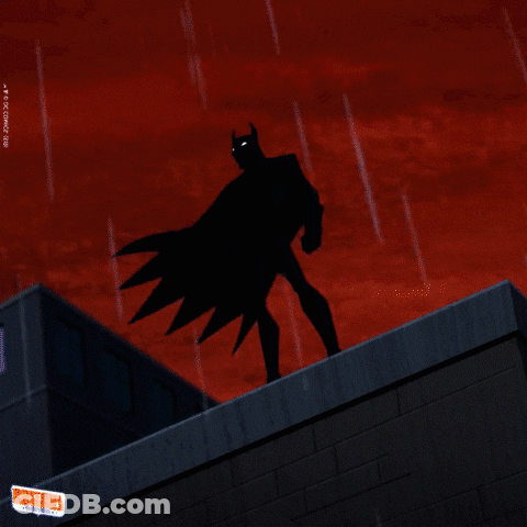 A Cartoon Of Batman Standing On Top Of A Building With A Lightning Bolt Behind Him GIF