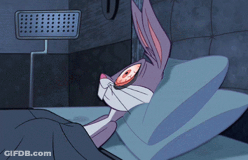 A Cartoon Of Bugs Bunny Laying In Bed With His Eyes Open GIF