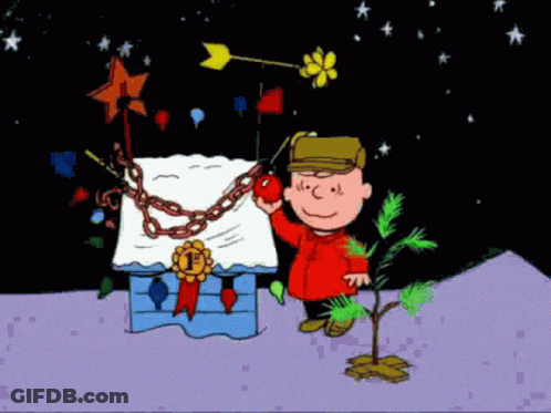 A Cartoon Of Charlie Brown Holding An Apple Next To A Tree GIF