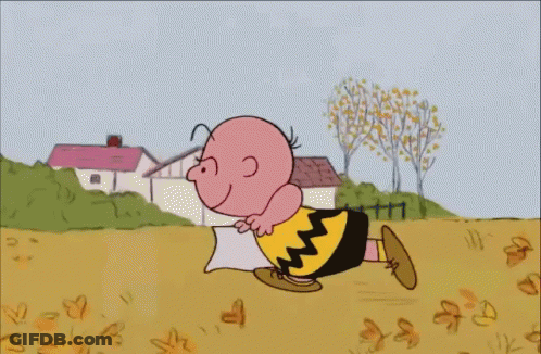 A Cartoon Of Charlie Brown Is Holding A Pillow GIF