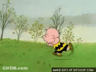 A Cartoon Of Charlie Brown Running In A Grassy Field GIF
