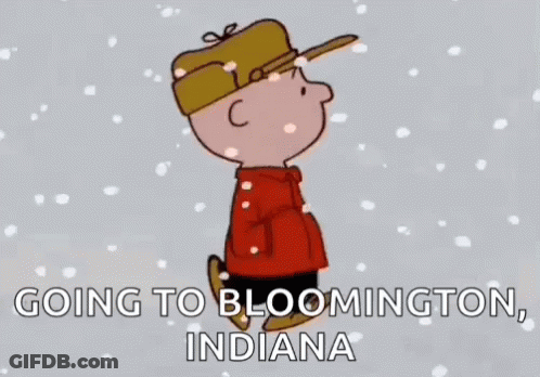 A Cartoon Of Charlie Brown Standing In The Snow With The Words `` Going To Bloomington , Indiana '' . GIF