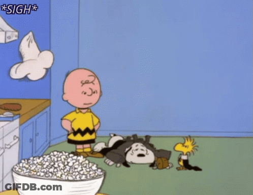 A Cartoon Of Charlie Brown Standing Next To A Bowl Of Popcorn With The Caption Sigh GIF