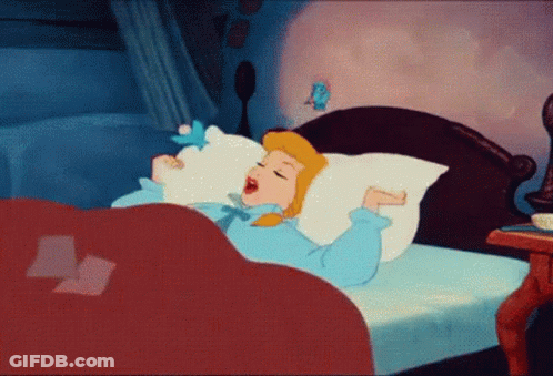 A Cartoon Of Cinderella Yawning In Bed With A Bird On Her Pillow . GIF