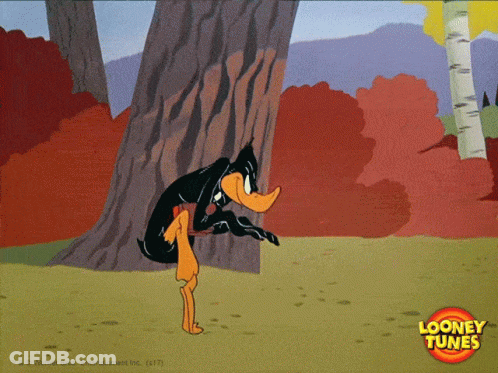 A Cartoon Of Daffy Duck Peeking Out From Behind A Tree With A Looney Tunes Logo In The Corner GIF