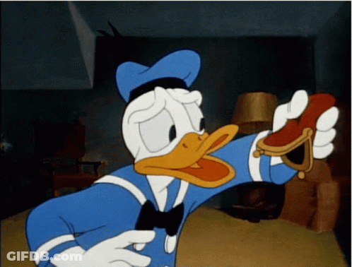 A Cartoon Of Donald Duck Holding A Red Object GIF