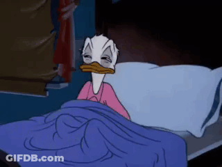 A Cartoon Of Donald Duck Laying In Bed GIF