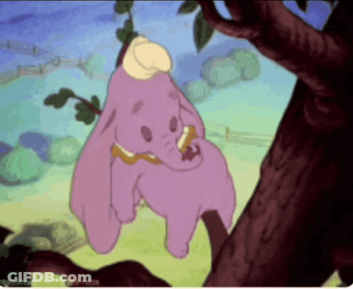 A Cartoon Of Dumbo Hanging On A Tree Branch GIF