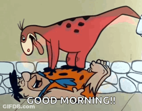 A Cartoon Of Flintstone Laying On The Ground With A Dinosaur Standing On Top Of Him GIF